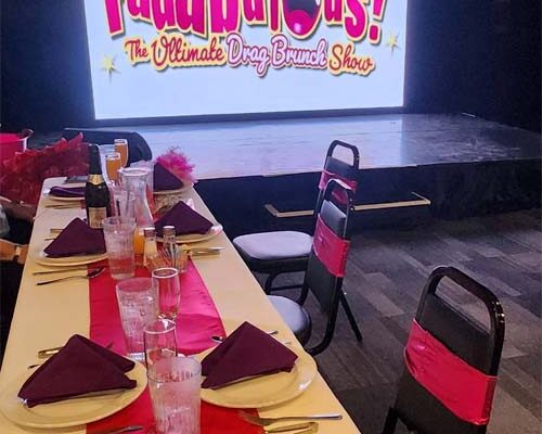Drag brunch tables and stage with sign