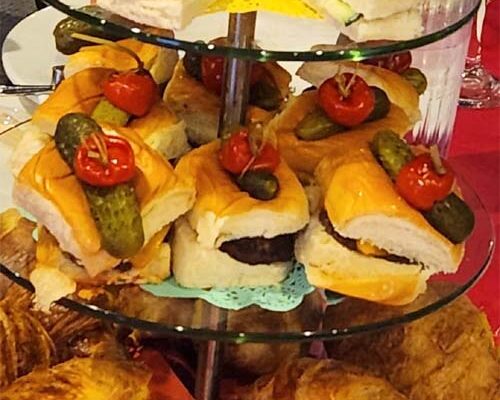 Tiered platter of assorted sandwiches and pastries